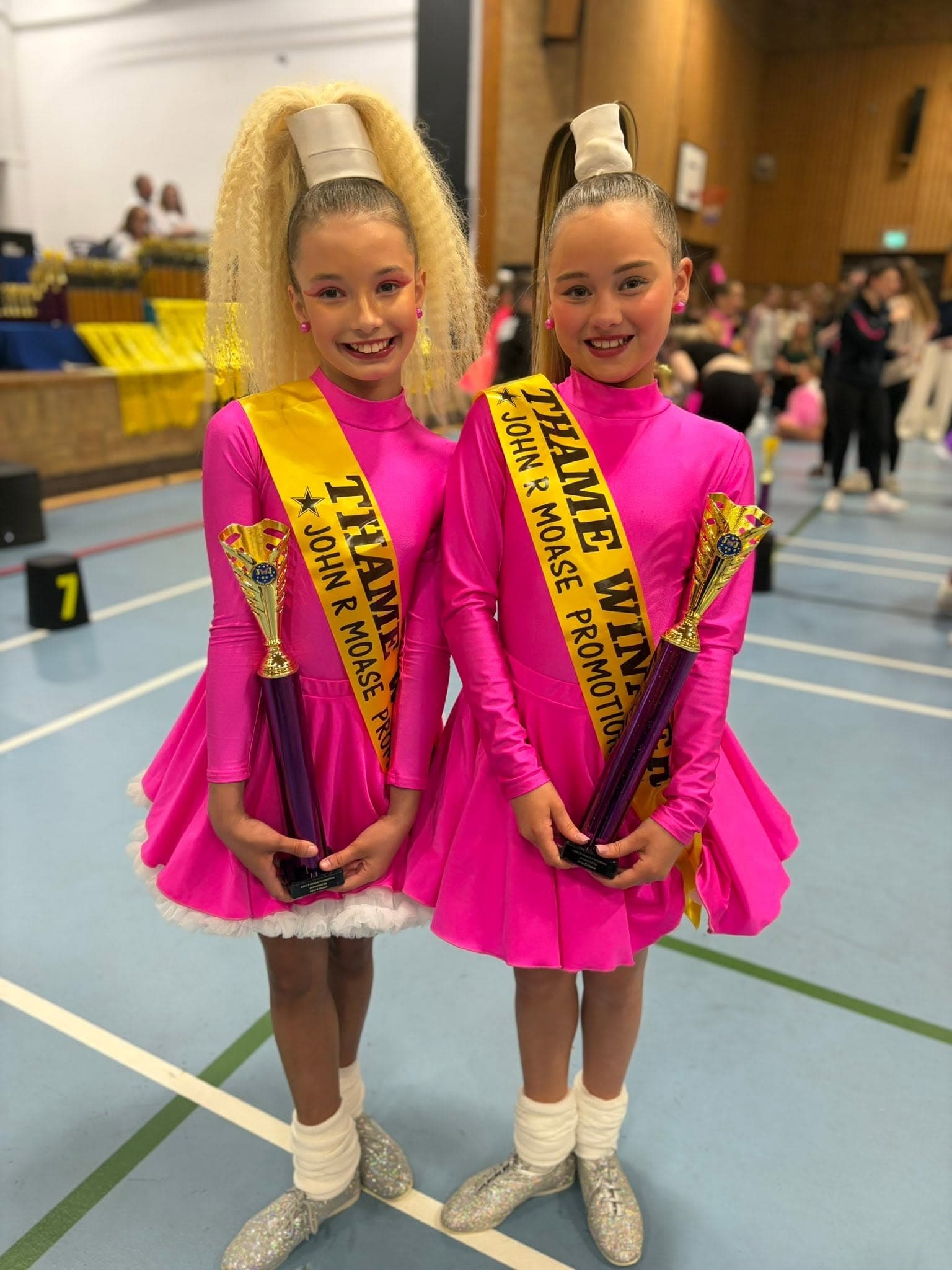 Pairs winners in neon pink costumes